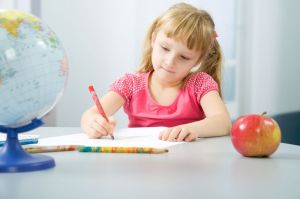 Girl writing with colored pencil